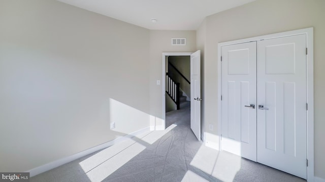 hallway featuring light carpet