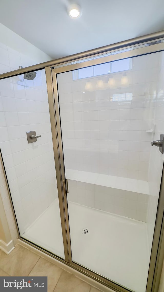 bathroom featuring an enclosed shower and tile patterned floors