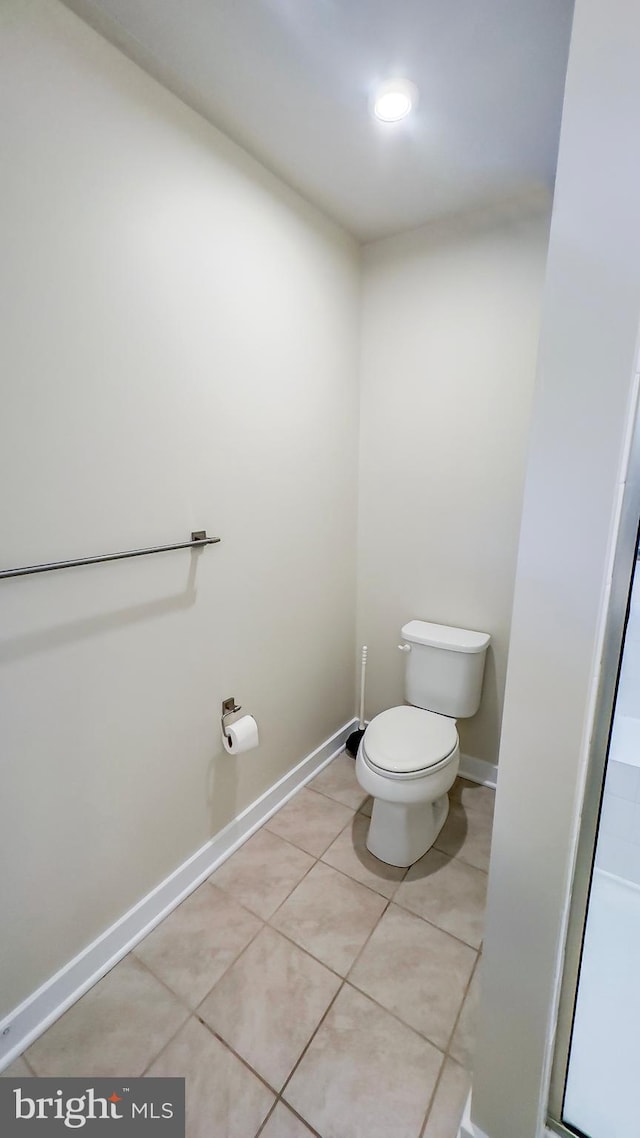 bathroom with tile patterned flooring and toilet