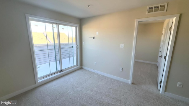 unfurnished room with light colored carpet