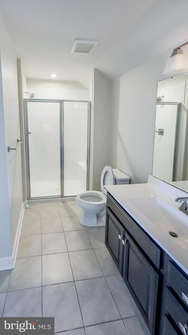 bathroom with toilet, tile patterned flooring, an enclosed shower, and vanity