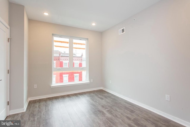 spare room with hardwood / wood-style flooring