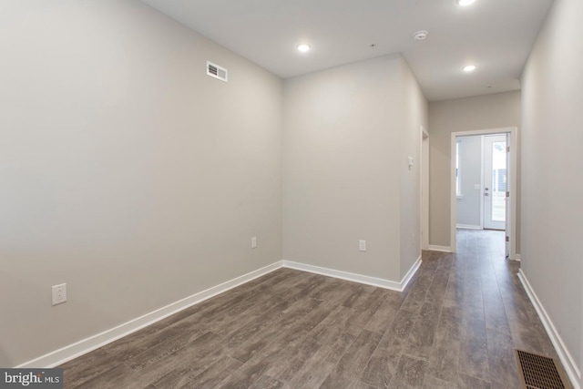 unfurnished room with dark wood-type flooring