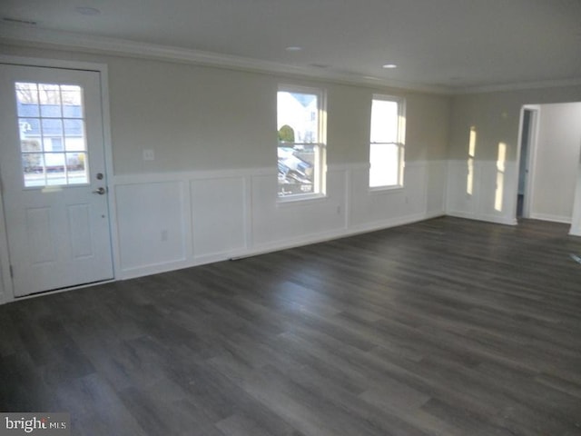 foyer featuring dark hardwood / wood-style flooring, plenty of natural light, and crown molding