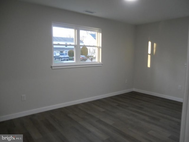 empty room featuring dark hardwood / wood-style flooring