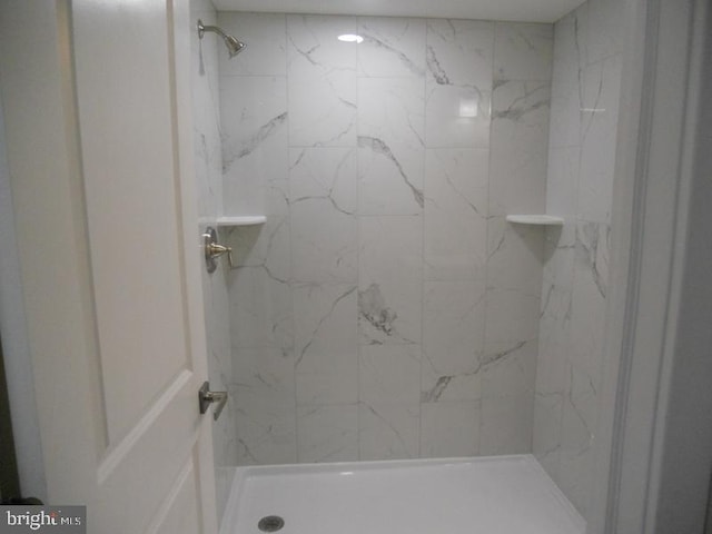 bathroom with tiled shower