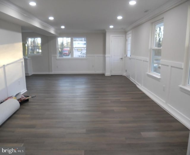 empty room featuring crown molding and dark wood-type flooring