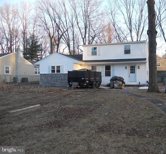 back of property featuring central AC