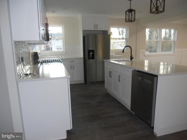 kitchen with sink, a center island, stainless steel refrigerator with ice dispenser, and black dishwasher