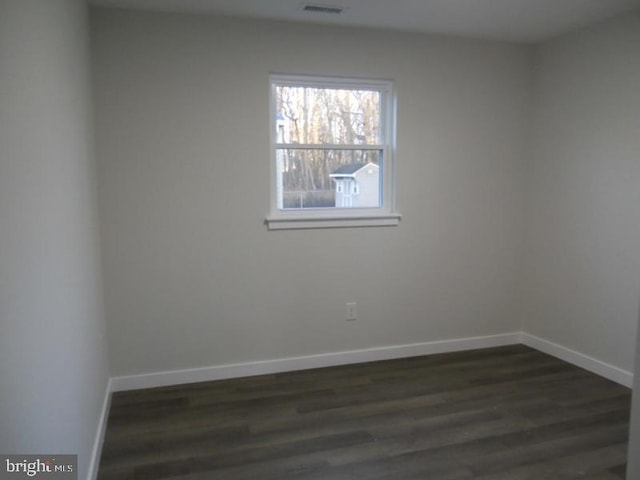 unfurnished room with dark hardwood / wood-style flooring