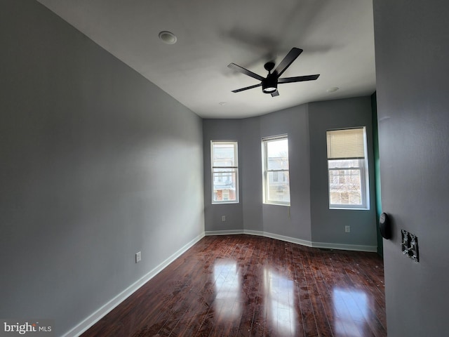 unfurnished room with dark hardwood / wood-style floors and ceiling fan