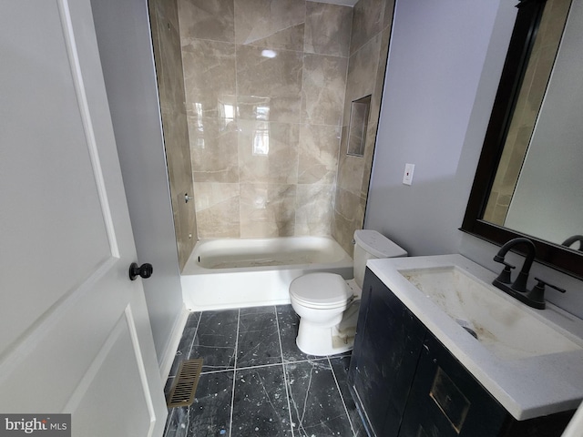 full bathroom featuring vanity, tiled shower / bath combo, and toilet