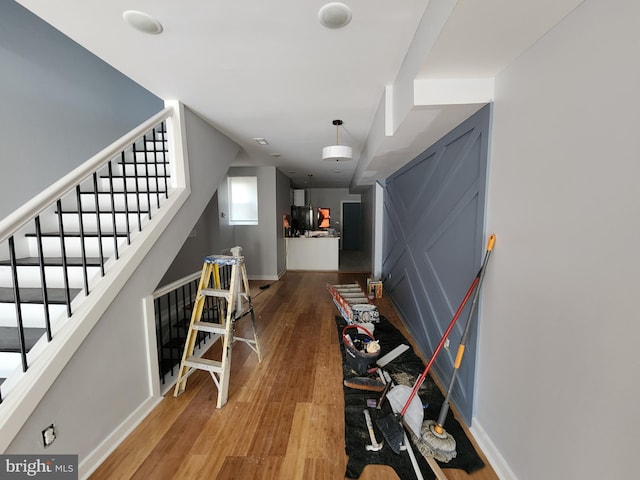 corridor with hardwood / wood-style floors