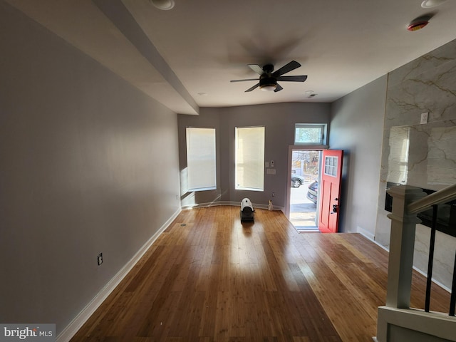 unfurnished living room with ceiling fan and hardwood / wood-style flooring