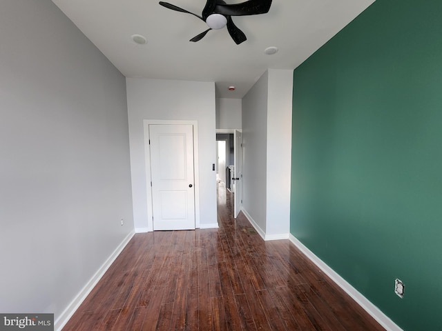 spare room featuring dark hardwood / wood-style floors and ceiling fan