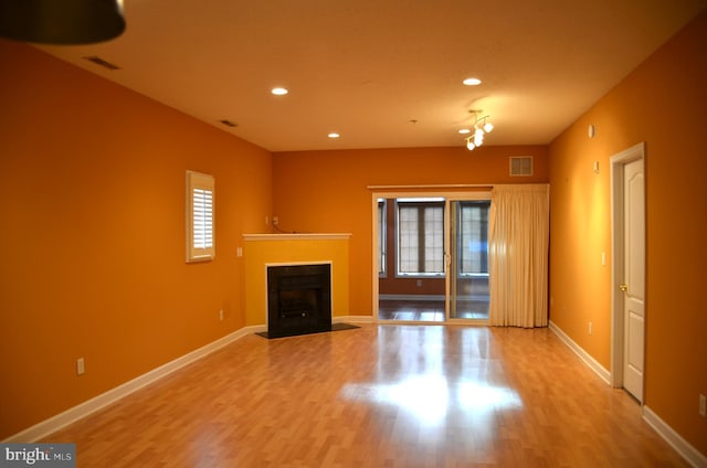 unfurnished living room featuring light wood-type flooring