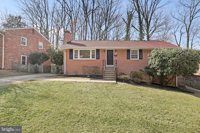 ranch-style home with brick siding, a chimney, a front yard, and fence