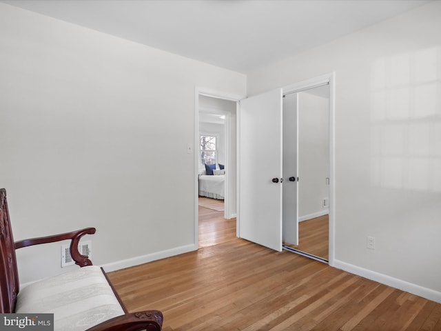 unfurnished room featuring baseboards and wood finished floors