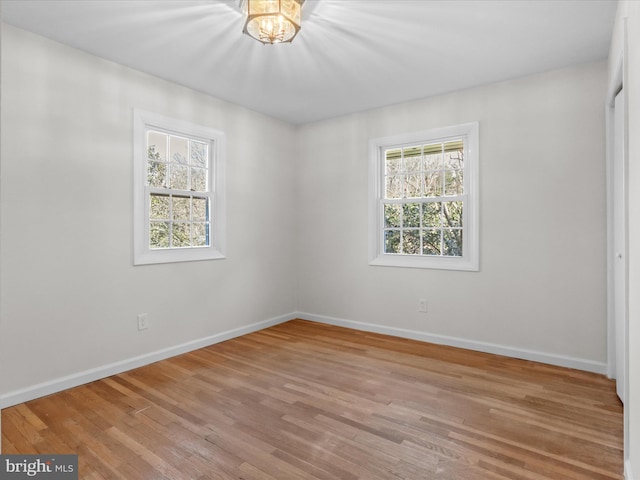 unfurnished bedroom with light wood-type flooring and baseboards