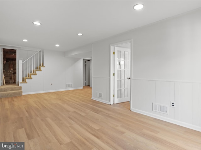 unfurnished living room with visible vents, recessed lighting, stairway, and light wood-style floors