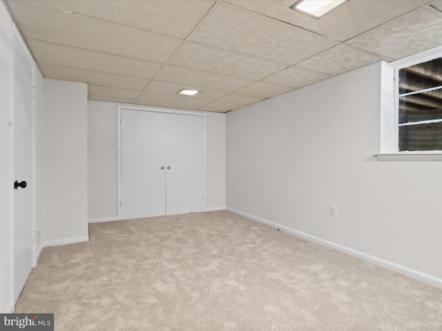 finished below grade area featuring baseboards and carpet