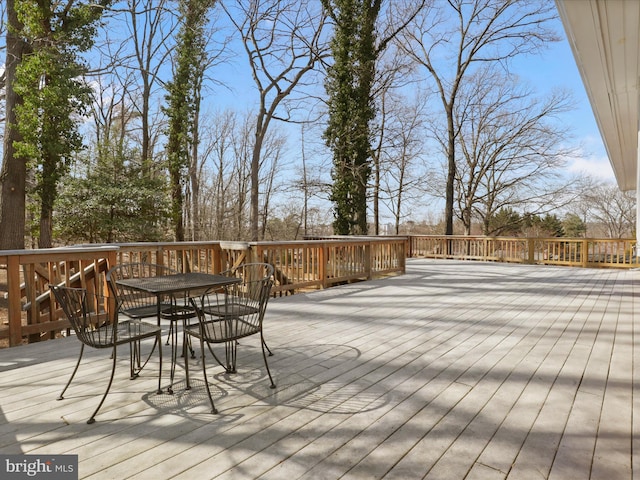 wooden deck featuring outdoor dining space