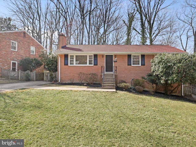 ranch-style house featuring brick siding, a chimney, a front lawn, and fence