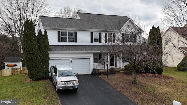 view of front of house with a garage and a front lawn