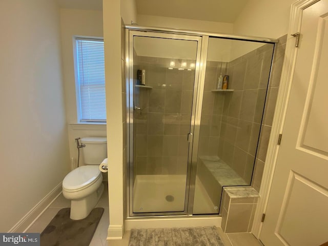 bathroom with tile patterned flooring, a shower with door, and toilet