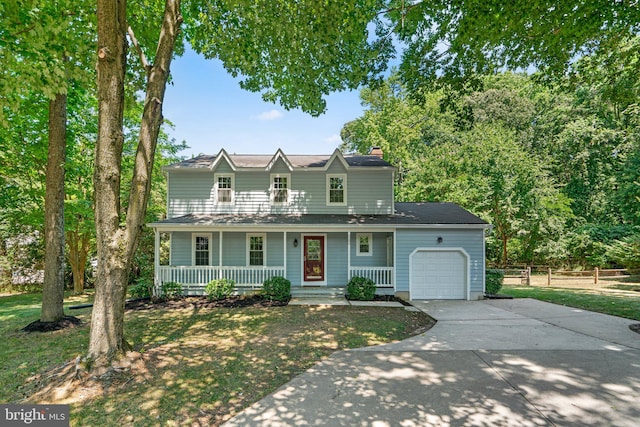 view of property featuring a front yard, a porch, and a garage