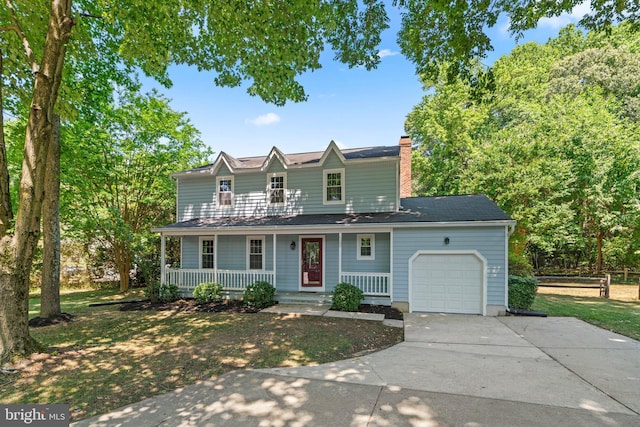 view of front of house featuring a front lawn, a porch, and a garage