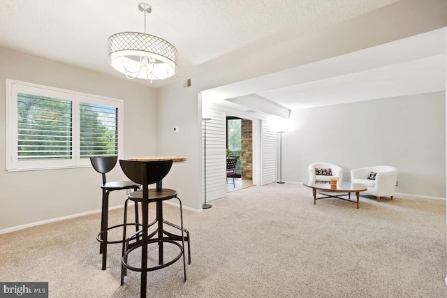 living area with a textured ceiling and light carpet