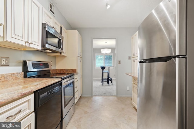 kitchen featuring light stone countertops, appliances with stainless steel finishes, light carpet, pendant lighting, and a notable chandelier