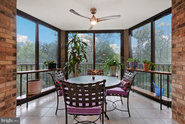 sunroom / solarium featuring ceiling fan and a healthy amount of sunlight