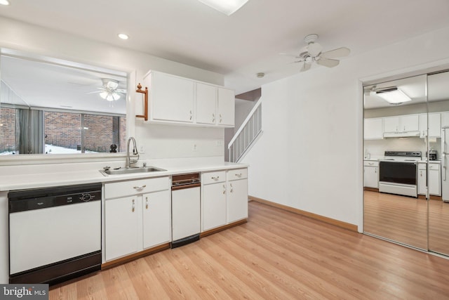 kitchen featuring white appliances, sink, ceiling fan, light hardwood / wood-style floors, and white cabinetry