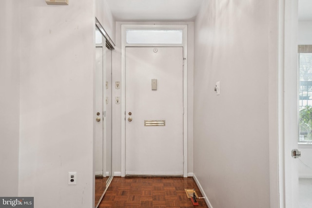 doorway with dark parquet floors