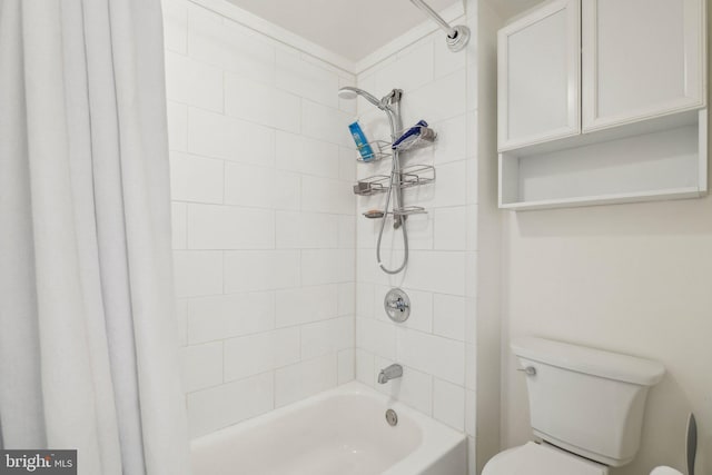 bathroom featuring shower / bath combo and toilet