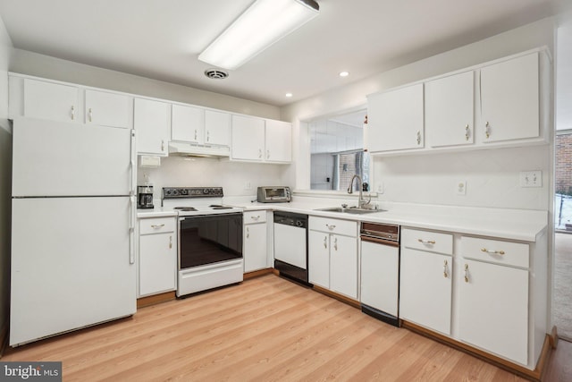 kitchen with white cabinetry, white appliances, sink, and light hardwood / wood-style flooring