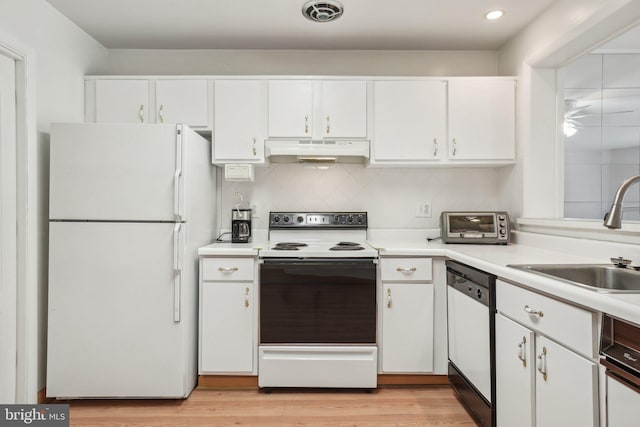 kitchen featuring tasteful backsplash, sink, white cabinets, and white appliances