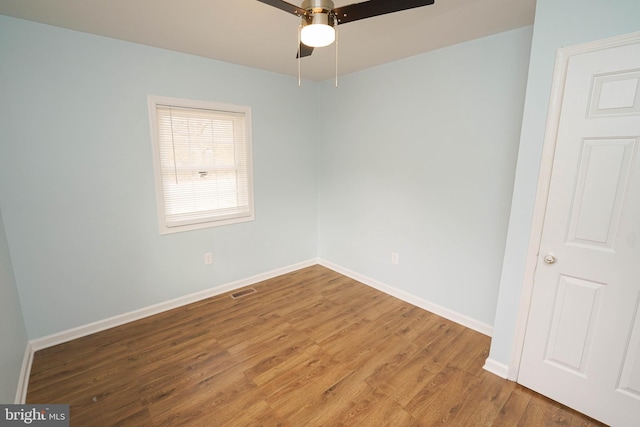 spare room featuring hardwood / wood-style flooring and ceiling fan