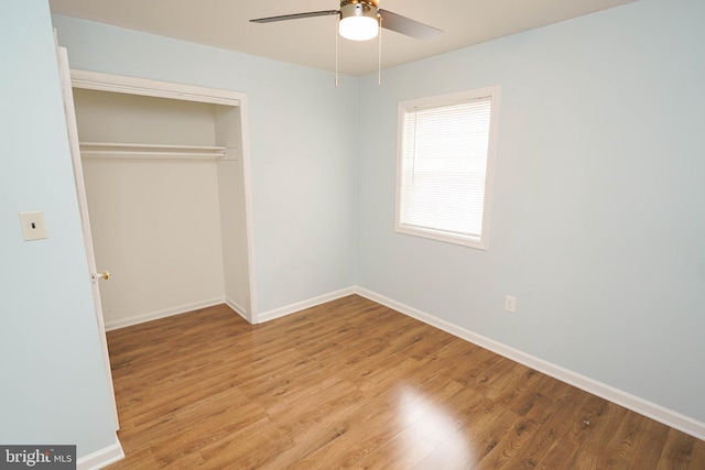 unfurnished bedroom with ceiling fan, light hardwood / wood-style floors, and a closet