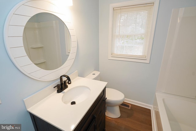 bathroom with vanity, wood-type flooring, and toilet