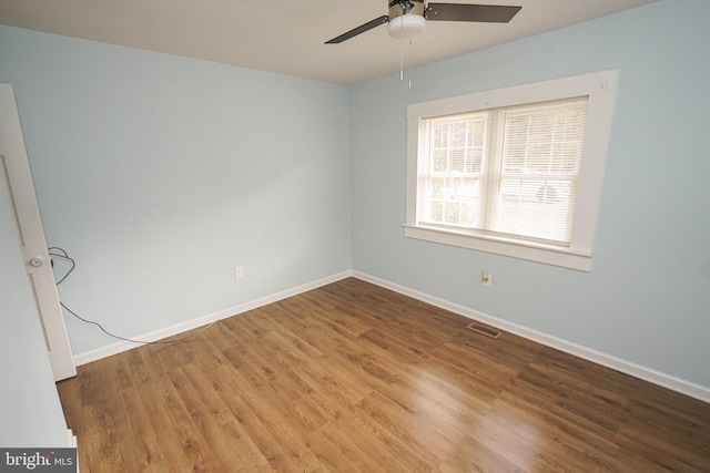 unfurnished room with hardwood / wood-style flooring and ceiling fan