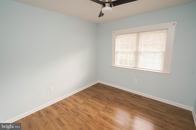 empty room featuring ceiling fan and dark hardwood / wood-style flooring