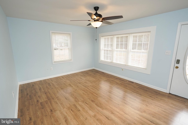 empty room with light wood-type flooring and ceiling fan