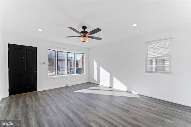 unfurnished living room featuring hardwood / wood-style floors and ceiling fan