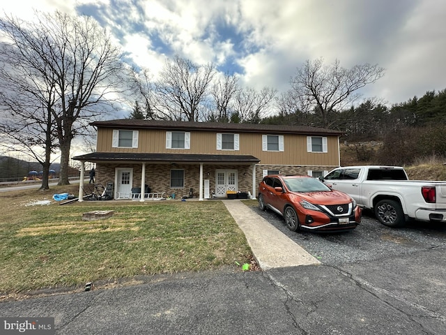 view of front of home with covered porch and a front yard