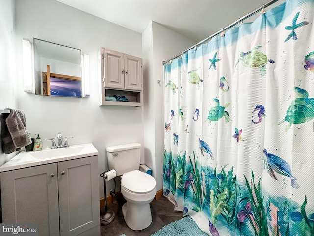 bathroom with vanity, toilet, and walk in shower