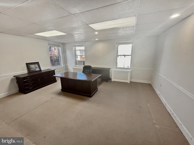 carpeted home office featuring a drop ceiling and a wealth of natural light