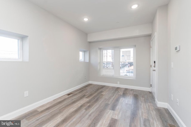 empty room featuring light hardwood / wood-style flooring and a healthy amount of sunlight